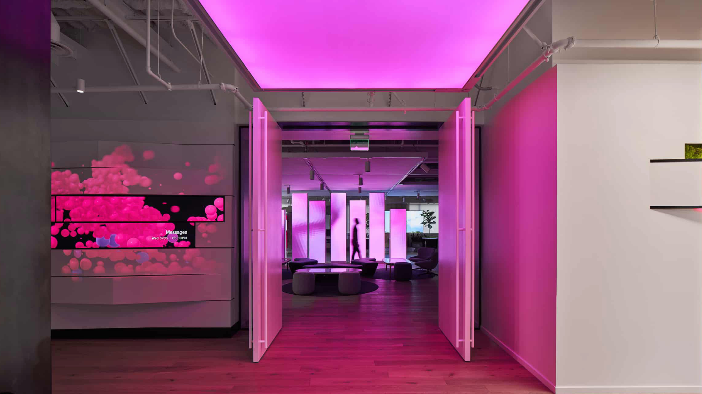 Magenta-lit doorway into the T-Mobile 5G & Me Innovation Center lounge; opens the AVI-SPL project case study