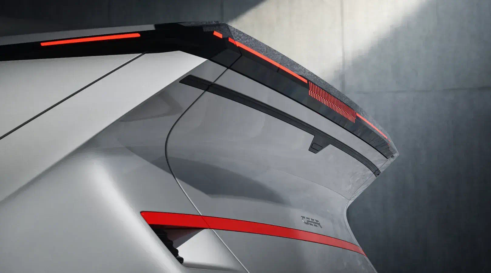 Detail of a silver CEER car's rear spoiler and tailgate, traced with red light bars
