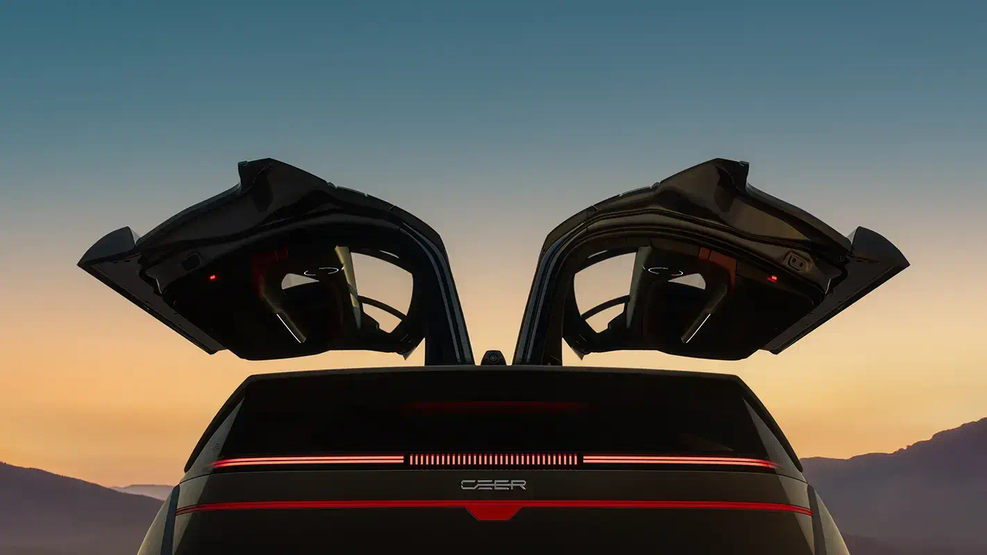 Rear view of the CEER SUV at dusk with both upward-opening doors raised and its rear light bar lit