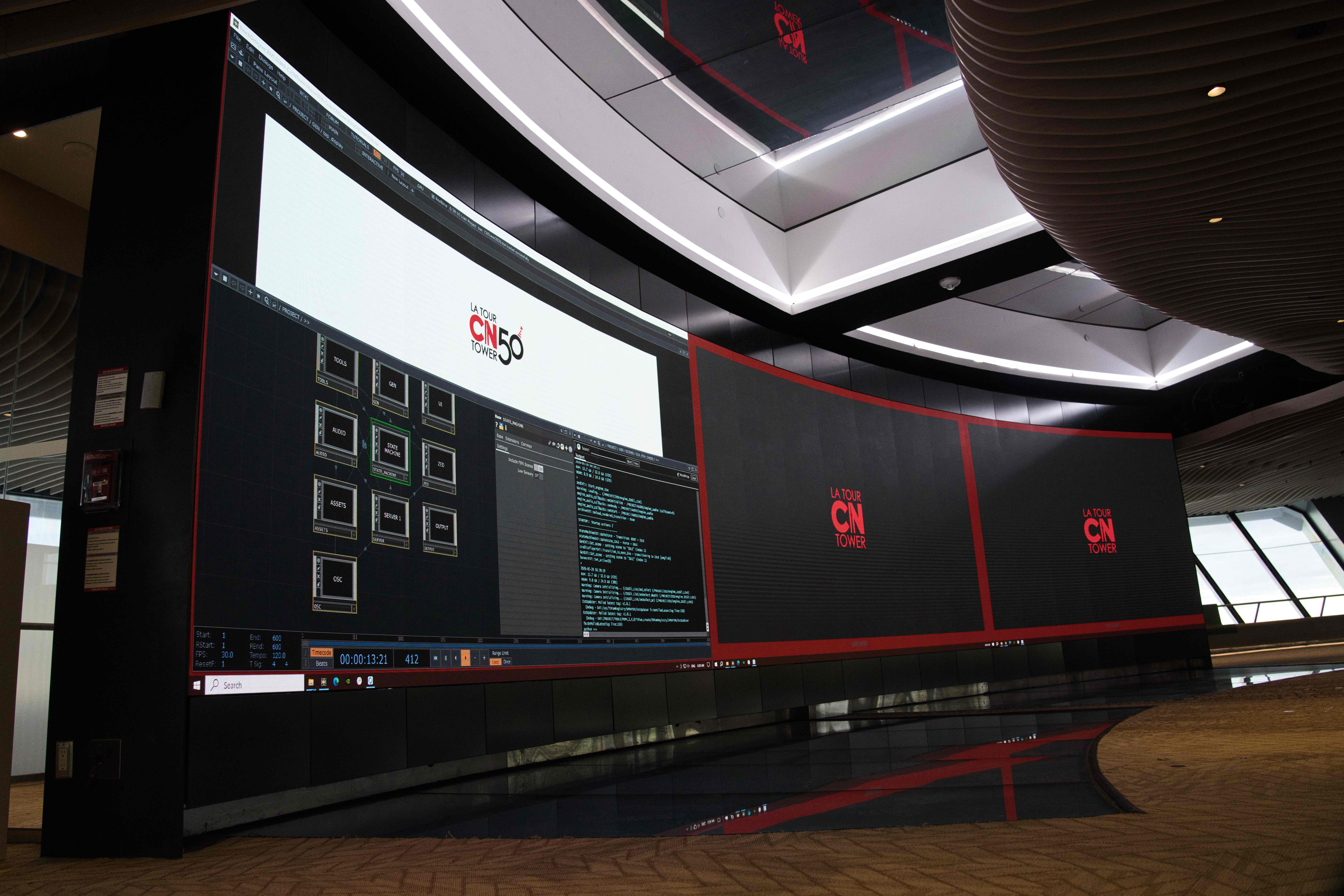 The video wall running show-control software beside the CN Tower 50 logo, with CN Tower logos on adjoining screens